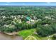Aerial view of a neighborhood surrounded by lush greenery and a tranquil lake at 106 April Walk, Mcdonough, GA 30253