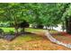 Picturesque backyard with a charming stream, lush greenery, and beautiful landscaping details at 106 April Walk, Mcdonough, GA 30253