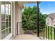 Cozy balcony with wrought iron railing overlooking lush greenery at 106 April Walk, Mcdonough, GA 30253