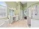 Bright and airy bathroom with dual vanities, tub, and walk-in shower at 106 April Walk, Mcdonough, GA 30253