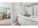 Bathroom with a double sink vanity, white cabinets, and a view into the bedroom at 106 April Walk, Mcdonough, GA 30253