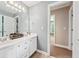 Bathroom featuring a double sink vanity, white cabinets, and views to the hallway at 106 April Walk, Mcdonough, GA 30253