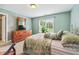 Comfortable bedroom featuring green walls, neutral carpet, and a large window at 106 April Walk, Mcdonough, GA 30253