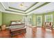Tranquil bedroom with tray ceiling, hardwood floors, and ample natural light at 106 April Walk, Mcdonough, GA 30253