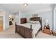 Bedroom with a wooden bedframe, carpeted floors, and an ensuite bathroom at 106 April Walk, Mcdonough, GA 30253