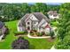 Stunning two-story home with manicured landscaping, a circular driveway, and an elegant entryway, providing exceptional curb appeal at 106 April Walk, Mcdonough, GA 30253