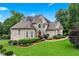 Beautiful two-story home with stone accents, lush lawn, and mature trees at 106 April Walk, Mcdonough, GA 30253