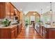 Spacious kitchen with hardwood floors and stainless steel appliances open to an adjacent living space at 106 April Walk, Mcdonough, GA 30253
