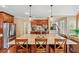 Spacious kitchen island with granite countertop, wooden chairs and pendant lights at 106 April Walk, Mcdonough, GA 30253