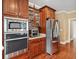 Gourmet kitchen featuring stainless steel appliances and rich wood cabinetry at 106 April Walk, Mcdonough, GA 30253