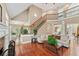 Bright living room with hardwood floors, staircase, and seamless flow to other living spaces at 106 April Walk, Mcdonough, GA 30253