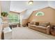 Comfortable living room offers a neutral-toned sofa, bright windows providing natural light, and additional seating and storage solutions at 106 April Walk, Mcdonough, GA 30253