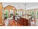 Open-concept living space featuring hardwood floors, a large island, and natural lighting at 106 April Walk, Mcdonough, GA 30253