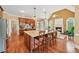 Open-concept living space featuring hardwood floors, a large island, and comfortable seating at 106 April Walk, Mcdonough, GA 30253