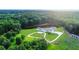 Aerial view showing a secluded estate with a circular driveway and pond on a sprawling lot at 1169 Hodges Cir, Mansfield, GA 30055