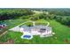 Stunning aerial view of estate featuring a pool, patio, long driveway, lush lawn and garden, surrounded by dense trees at 1169 Hodges Cir, Mansfield, GA 30055