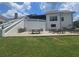 Spacious backyard with a large patio, multiple seating areas, and a manicured lawn at 1169 Hodges Cir, Mansfield, GA 30055