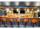 This wet bar features wooden cabinetry, lighting, and barstool seating at 1169 Hodges Cir, Mansfield, GA 30055