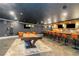 Basement with a pool table, bar, and lounge seating provides ample space for entertaining guests at 1169 Hodges Cir, Mansfield, GA 30055
