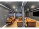 Basement lounge area with leather seating, stylish decor, and an aquarium feature at 1169 Hodges Cir, Mansfield, GA 30055