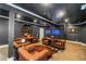 Basement lounge area with leather seating, stylish decor, and an aquarium feature at 1169 Hodges Cir, Mansfield, GA 30055