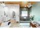 Well-lit bathroom featuring a glass shower, double vanities, stone floors and a free standing bathtub at 1169 Hodges Cir, Mansfield, GA 30055