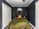 A bedroom has dark walls, white ceilings, and neutral decor at 1169 Hodges Cir, Mansfield, GA 30055