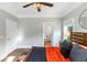 Bright bedroom features a ceiling fan and an ensuite bathroom for added convenience at 1169 Hodges Cir, Mansfield, GA 30055