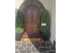 Elegant arched front door with decorative plants and a welcoming entrance mat at 1169 Hodges Cir, Mansfield, GA 30055
