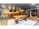 Entertaining game room featuring a pool table, custom bar and multiple seating options at 1169 Hodges Cir, Mansfield, GA 30055