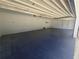 Spacious three-car garage interior with freshly painted walls and a durable floor at 1169 Hodges Cir, Mansfield, GA 30055