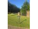 Stone gate entrance with black wooden fence; keypad and tree in lawn at the property entrance at 1169 Hodges Cir, Mansfield, GA 30055