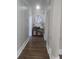 Hallway with beautiful wooden floors, neutral paint and trim and stylish decorations at 1169 Hodges Cir, Mansfield, GA 30055