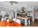 Well-appointed kitchen with island cooktop, stainless appliances, bar stool seating and open dining space at 1169 Hodges Cir, Mansfield, GA 30055