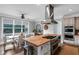 Modern kitchen with a central island, stainless steel appliances, and adjacent dining area with abundant natural light at 1169 Hodges Cir, Mansfield, GA 30055