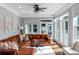 Bright living room with large windows, comfortable seating, and stylish decor at 1169 Hodges Cir, Mansfield, GA 30055