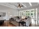 Spacious living room boasts coffered ceiling, large windows, and open access to the kitchen at 1169 Hodges Cir, Mansfield, GA 30055