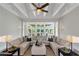 Open living room area featuring coffered ceiling, large windows and a comfortable sofa at 1169 Hodges Cir, Mansfield, GA 30055