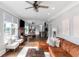 Open-concept living room with hardwood floors, comfortable seating, and great natural light at 1169 Hodges Cir, Mansfield, GA 30055