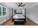 Spacious main bedroom featuring dark-stained wood floors and large windows at 1169 Hodges Cir, Mansfield, GA 30055