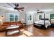 Main bedroom features a leather couch, dark-stained wood floors and large windows at 1169 Hodges Cir, Mansfield, GA 30055