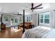 Main bedroom features leather couch, dark-stained wood floors and large windows with access to a patio at 1169 Hodges Cir, Mansfield, GA 30055