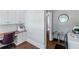 Office area including cabinets, desk and chair with access to laundry area at 1169 Hodges Cir, Mansfield, GA 30055