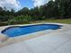 Inviting in-ground pool with a concrete surround and water features, set in a lush backyard at 1169 Hodges Cir, Mansfield, GA 30055