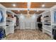 Spacious walk-in closet featuring custom shelving, brick floors, chandelier, and wooden ceiling at 1169 Hodges Cir, Mansfield, GA 30055
