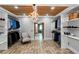Custom walk-in closet with brick flooring, white shelving, chandelier, and an entrance to the bathroom at 1169 Hodges Cir, Mansfield, GA 30055