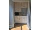 Stylish wet bar with a sink, white shaker cabinets, subway tile backsplash, and hardwood floors at 1169 Hodges Cir, Mansfield, GA 30055