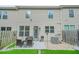 Townhome backyard featuring a patio with seating, stone landscape, and private fencing at 3246 Spicy Cedar Ln, Lithonia, GA 30038