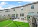 Townhome backyard featuring a patio with seating, stone landscape, and private fencing at 3246 Spicy Cedar Ln, Lithonia, GA 30038