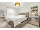 Bright bedroom with upholstered bed, modern dresser, and natural light at 3246 Spicy Cedar Ln, Lithonia, GA 30038